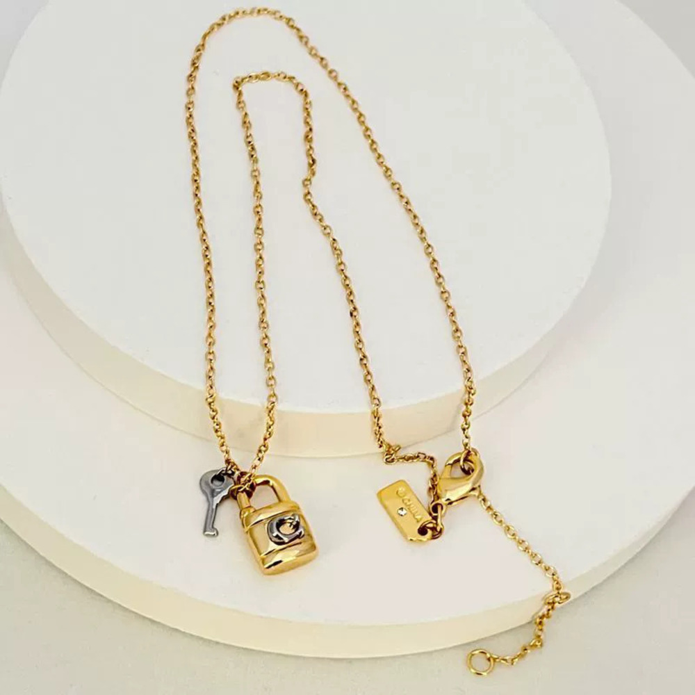 Coach Gold Silver Mixed Lock and Key Pendant Necklace